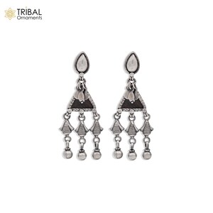 May include: Silver dangle earrings with a triangular pendant and three tiers of small bells. The pendant has a black center and a silver border.