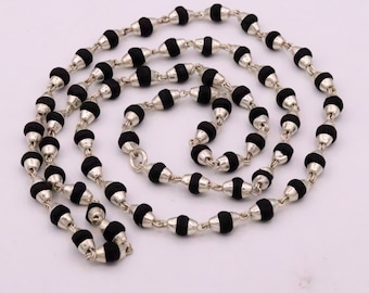 May include: A black and silver beaded necklace with a silver chain. The beads are round and have a black finish.