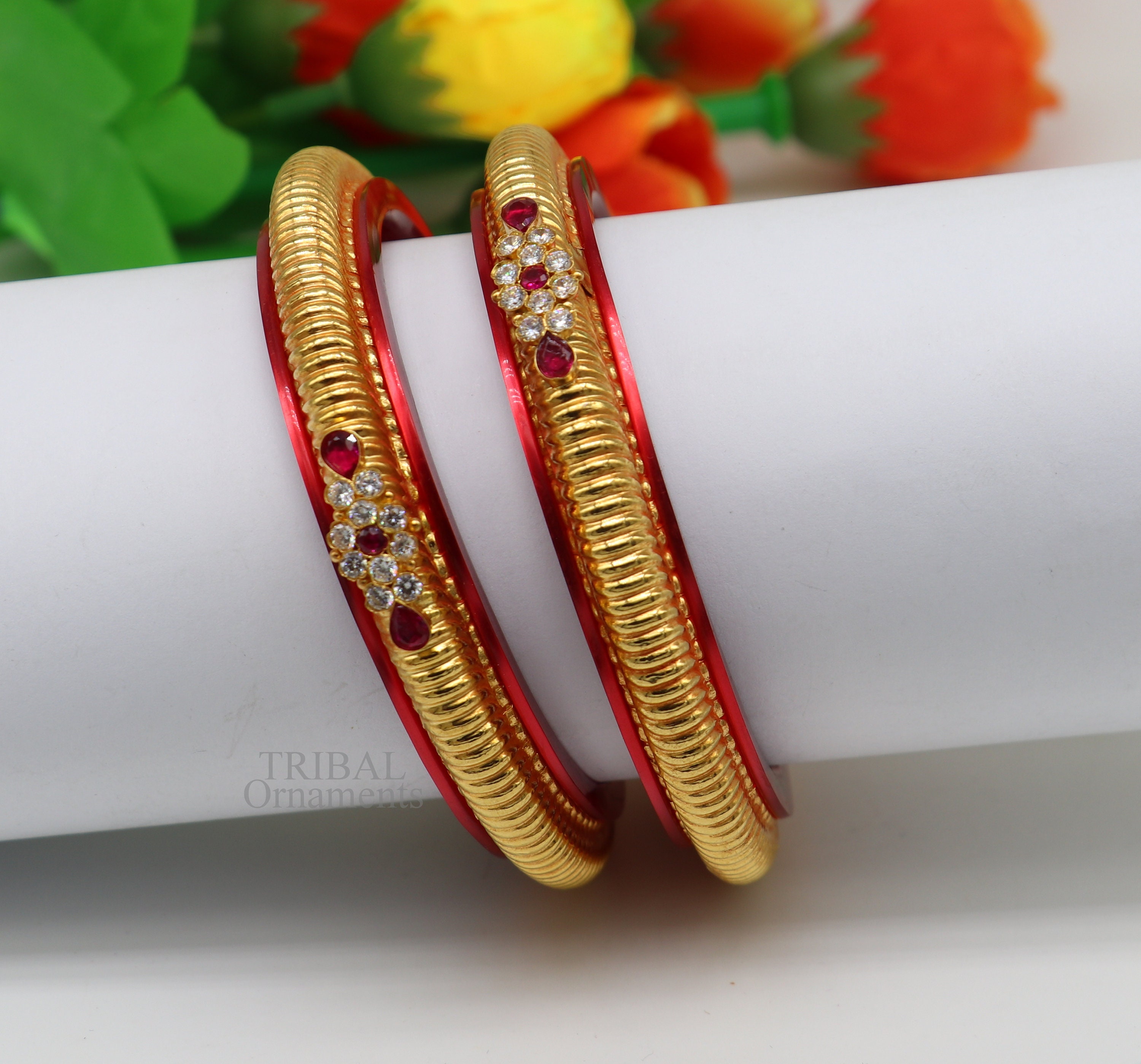 Gold bangles with red plastic deals