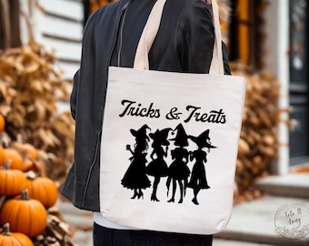 May include: A cream-coloured tote bag with the words "Tricks & Treats" in black script. Below the text are black silhouettes of four witches. The bag has cream-coloured handles.