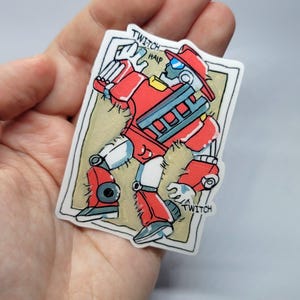 May include: A sticker featuring a red robot firefighter with a ladder on its chest, wearing a red hat and blue visor. The robot is in a dynamic pose, with the words "TWITCH HALP" and "TWITCH" on the sticker.