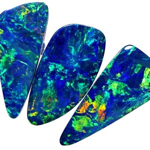 May include: Three teardrop-shaped opals with a blue, green, and gold iridescent sheen.