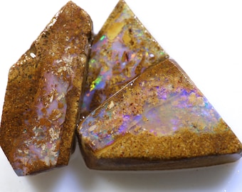 May include: Three pieces of rough opal with brown matrix and iridescent flashes of colour.