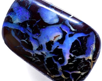 May include: A dark blue and black opal with a unique pattern of white and blue veins. The opal has a high polish and is a beautiful example of this type of gemstone.