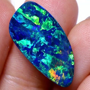 May include: A blue, green, and iridescent opal gemstone with a teardrop shape.