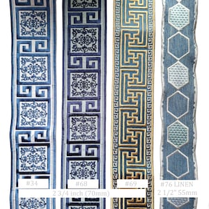 May include: Decorative trim ribbons in various blue and gold patterns. Designs include geometric shapes and floral motifs. One ribbon is 2 3/4 inches (70mm) wide, another is 2 1/2 inches (55mm) wide. The ribbons are labeled with numbers.