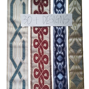 May include: A selection of decorative ribbons with diverse patterns. The ribbons display designs in blue, red, and gold, with geometric and ornate motifs. The text "30+ DESIGNS" is handwritten on a white piece of paper.
