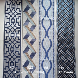 May include: Four decorative fabric ribbons with geometric patterns in shades of blue, gray, and beige. The ribbons vary in width, with the widest being 4 inches (95mm). Each ribbon has a unique design, including interlocking shapes and woven patterns. The image includes the text "#2", "#22", "#8", and "#41".