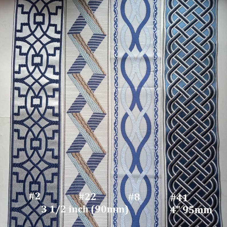May include: Four decorative fabric ribbons with geometric patterns in shades of blue, gray, and beige. The ribbons vary in width, with the widest being 4 inches (95mm). Each ribbon has a unique design, including interlocking shapes and woven patterns. The image includes the text "#2", "#22", "#8", and "#41".