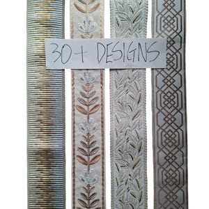 May include: Four vertical strips of decorative fabric trim featuring distinct patterns including horizontal stripes, floral motifs, leafy vines, and geometric shapes, with a white paper overlay displaying the handwritten text 30+ DESIGNS.