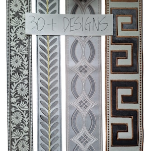May include: Four vertical strips of decorative fabric trim featuring distinct patterns. The first has white floral embroidery on a dark background, the second a grey leaf motif with a gold line, the third a grey geometric weave, and the fourth a brown Greek key pattern. Text reads 30+ DESIGNS.