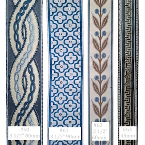 May include: Four decorative fabric ribbons with different patterns. The first has a blue and cream braided design. The second has a blue floral pattern with silver accents. The third has a brown and blue leaf design. The fourth has a geometric pattern.