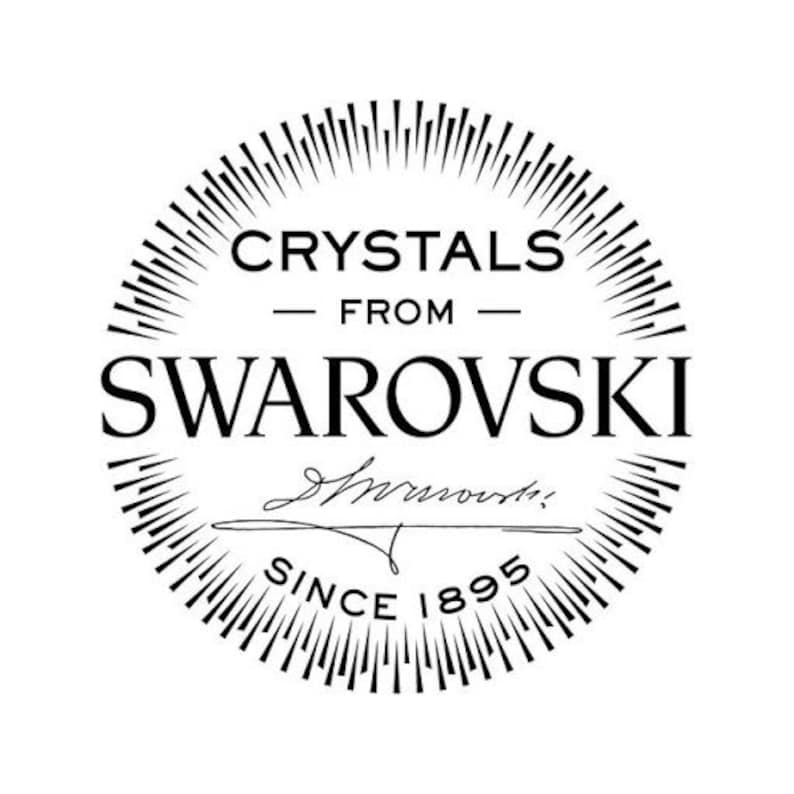 May include: Black and white logo for Swarovski crystals. The logo features a circle with radiating lines, the text "Crystals from Swarovski" and the signature "Swarovski" with the text "Since 1895" below.