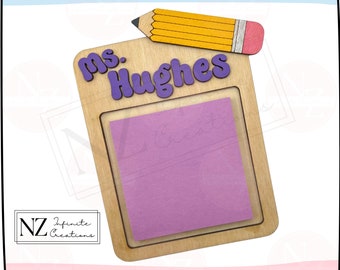May include: Wooden sign with a purple "Ms. Hughes" nameplate and a yellow pencil with a red eraser. A purple sticky note is in the center of the sign.
