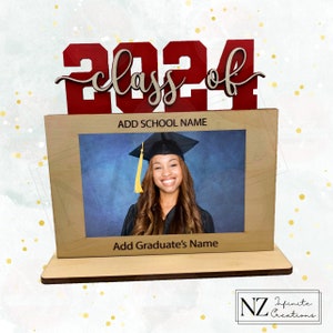 May include: A wooden picture frame with a red "Class of 2024" sign on top. The frame has a space for a photo and text that says "Add School Name" and "Add Graduate's Name".