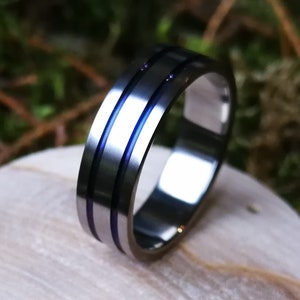 Unique handmade titanium ring with anodized channels.