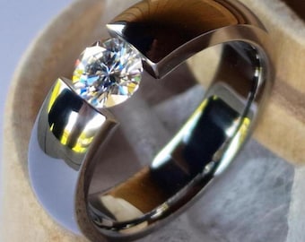 Titanium tension ring with round diamond cut stone setting. polished finish. Handmade and customizable.