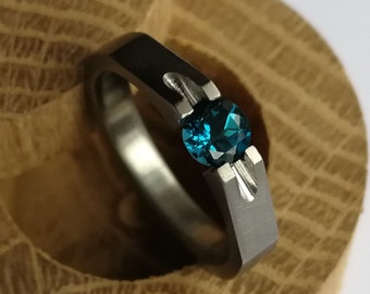 Titanium tension ring with round diamond cut stone setting. Brushed finish. Handmade and customizable.