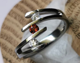 Titanium tension ring with round brilliant cut gemstone setting. Polished finish. Handmade and customizable.