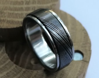 Stainless Damascus Steel and titanium spinner ring. Handmade and customizable.