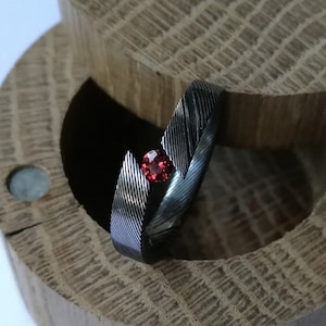 Unique handmade Stainless damascus steel tension ring with round brilliant cut stone setting.