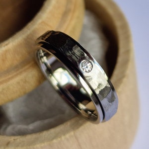 Flush set faceted titanium spinner band. Handmade and customizable.