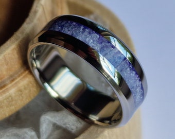 Handmade titanium band with natural tanzanite channel and bevelled edges.