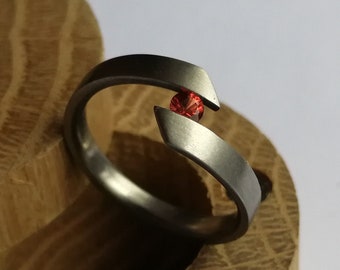 Titanium tension ring with round brilliant cut gemstone setting. Brushed finish. Handmade and customizable.