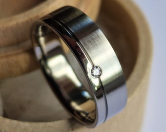 Titanium band with flush set gemstone. Two tone finish. Handmade and customizable.