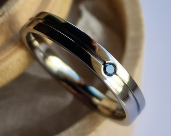 Polished titanium band with flush set gemstone. Minimalist stacking ring. Handmade and customizable.