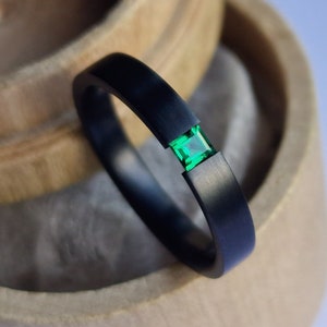 Black zirconium tension ring with princess cut stone setting. Brushed finish. Handmade and customizable.