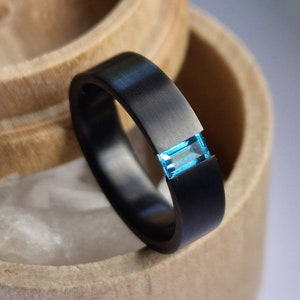 Black zirconium tension ring with diamond cut Stone setting. Brushed finish. Handmade and customizable.