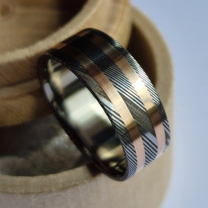 Titanium and Stainless damascus steel ring with two solid gold channels and titanium lining. Handmade and customizable.