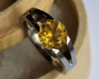 Titanium tension ring with round brilliant cut gemstone. Polished finish. Handmade and customizable.