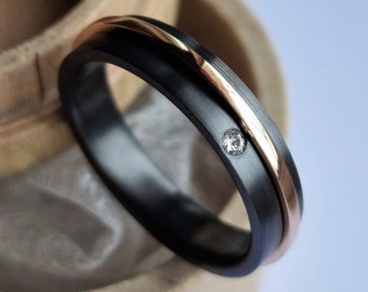 Black zirconium and solid gold spinner ring-band with flush set stone. Handmade and customizable.