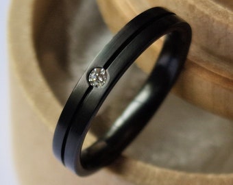 Black zirconium band with flush set gemstone. Minimalist stacking ring. Handmade and customizable.