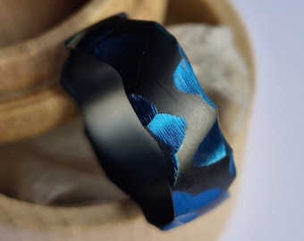 Black zirconium band with deep blue facets. Handmade and customizable.