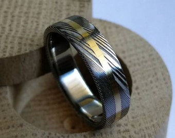 Stainless damascus steel ring with solid gold channel. Handmade and customizable.