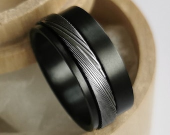 Black Zirconium and Stainless Damascus steel spinner ring. Handmade and customizable.
