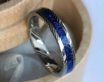 Stainless damascus steel band with Lapis Lazuli channel.