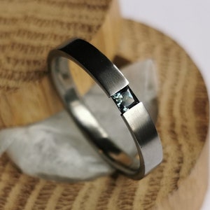 Titanium tension ring with princess cut gemstone setting. Brushed finish. Handmade and customizable.