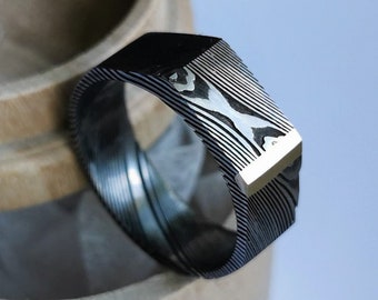 Stainless damascus steel signet style ring with yellow gold accent. Handmade and customizable.