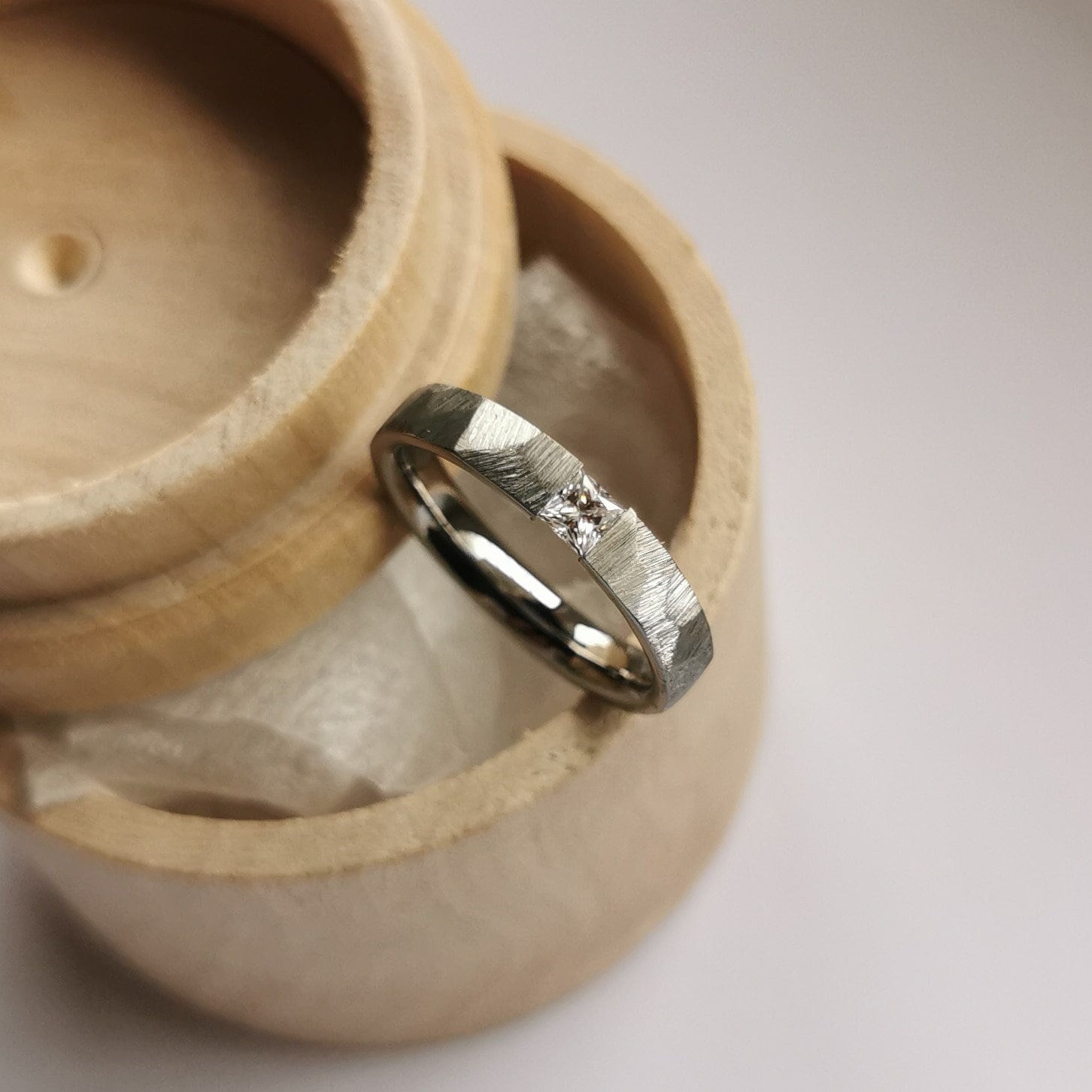 Faceted titanium tension ring with princess cut gemstone setting. Polished finish. Handmade and customizable.