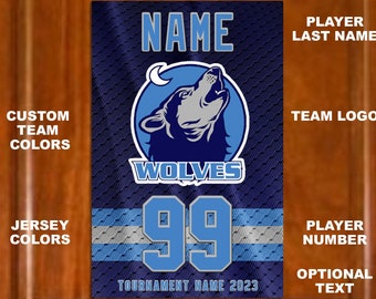 May include: A blue and white sports jersey with a wolf logo and the text "WOLVES" and "TOURNAMENT NAME 2023". The jersey has a number "99" on the front.