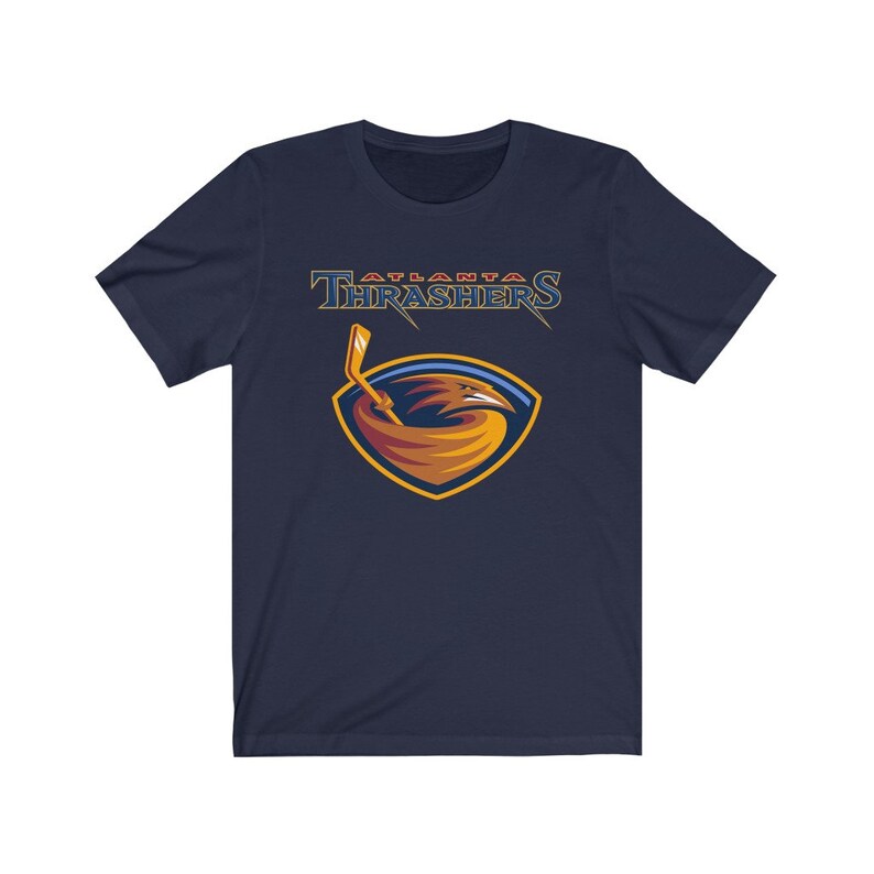 May include: A navy blue t-shirt with the Atlanta Thrashers logo. The logo features a red, orange, and yellow bird with a hockey stick in its beak. The text "Atlanta Thrashers" is above the logo.