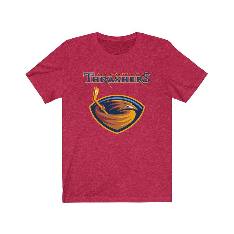 May include: Red t-shirt with a graphic of the Atlanta Thrashers NHL team logo. The logo features a gold and blue hawk with a hockey stick.