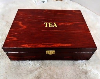 wooden lockable tea bag box with twelve compartments in brown color made of pine wood varnished and with elegant inscription tea