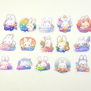 May include: A set of 15 colorful stickers featuring cute cartoon bunnies in various poses and settings. The stickers are perfect for adding a touch of whimsy to journals, laptops, water bottles, and more.