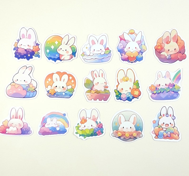 May include: A set of 15 colorful stickers featuring cute cartoon bunnies in various poses and settings. The stickers are perfect for adding a touch of whimsy to journals, laptops, water bottles, and more.