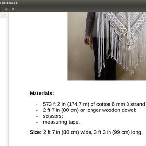 May include: A white macrame wall hanging with a geometric pattern. The hanging is 2 feet 7 inches wide and 3 feet 3 inches long. The materials needed to make this hanging are 573 feet 2 inches of cotton rope, a wooden dowel, scissors, and measuring tape.